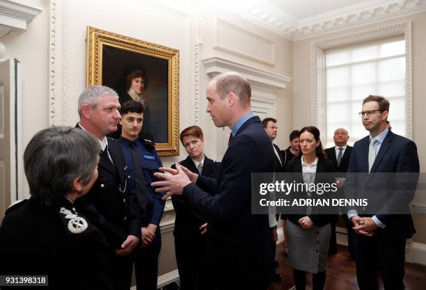 Britain's Prince William, Duke of Cambridge, talks with police officers including PC Shaun Cartright, who collected the Outstanding Bravery Award,...