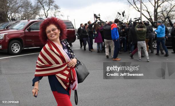Hong Saccone, wife of Republican Congressional Candidate Rick Saccone walks to their car while her husband is surrounded by media after voting in the...