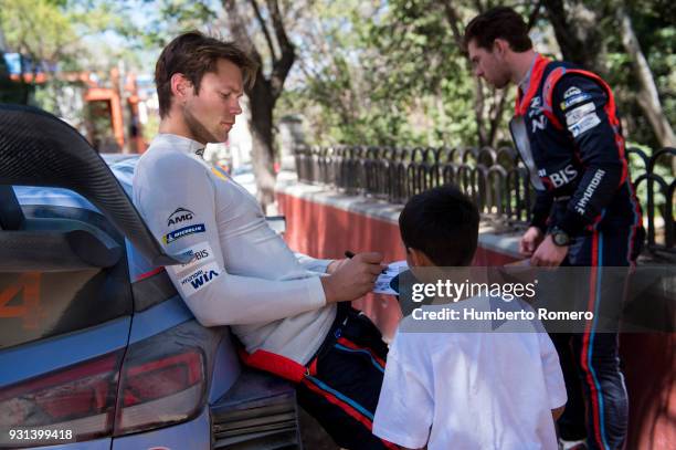 Andreas Mikkelsen and Jaeger Anders from Hyundai Shell Mobis WRC Team signs autographs before the last stage of the Rally Guanajuato Corona during...