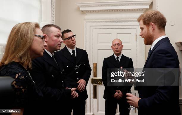 Prince Harry talks with Metropolitan Police officers as he and Prince William, Duke of Cambridge host the winners of The Met Excellence Awards at...