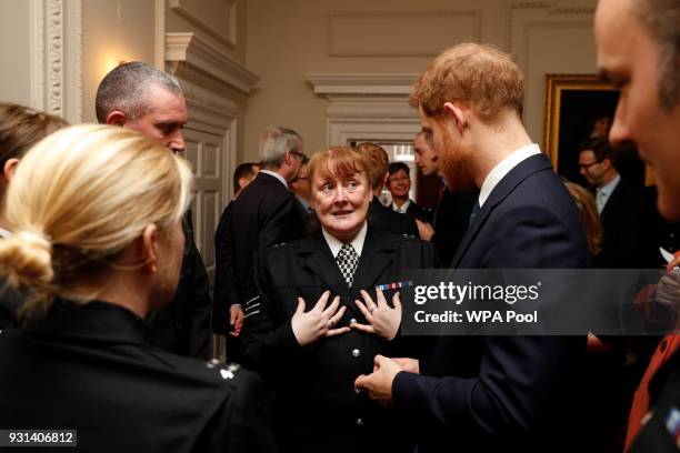 Prince Harry talks with Metropolitan Police officers as he and Prince William, Duke of Cambridge host the winners of The Met Excellence Awards at...