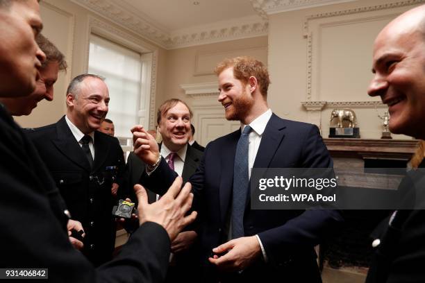 Prince Harry talks with Metropolitan Police officers as he and Prince William, Duke of Cambridge host the winners of The Met Excellence Awards at...