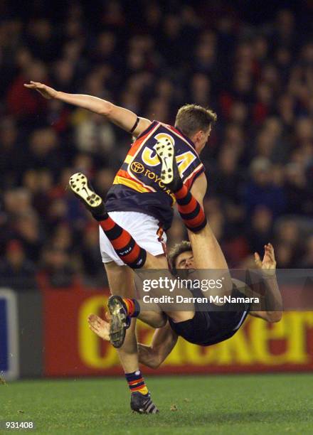 Matthew Lloyd for Essendon, is knocked off his feet by Ben Hart for Adelaide, during the match between the Essendon Bombers and the Adelaide Crows,...