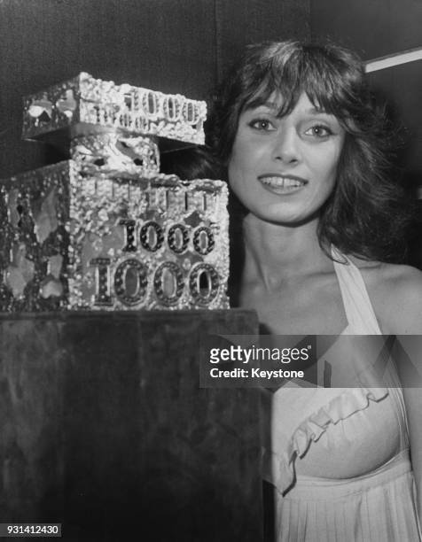 French actress Marie-Hélène Breillat with a jewelled perfume bottle created by Chaumet for Jean Patou's scent '1000', Paris, France, 17th October...