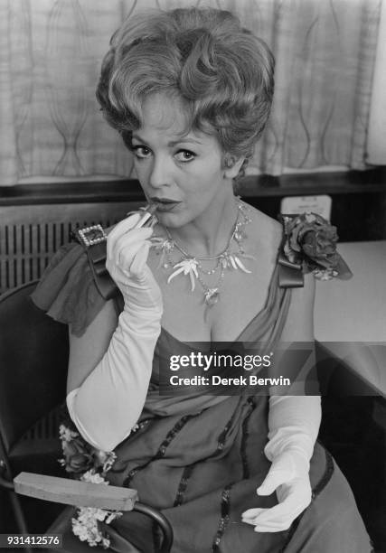 British actress and singer Patricia Bredin applies her make-up for her role in 'Bitter Sweet', an operetta by Noël Coward, 20th November 1964. Coward...