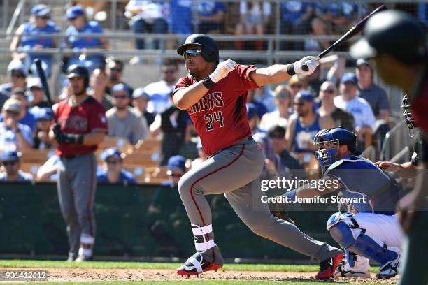 Yasmany Tomas of the Arizona Diamondbacks hits an RBI single in the third inning of a spring-training game against the Los Angeles Dodgers at...