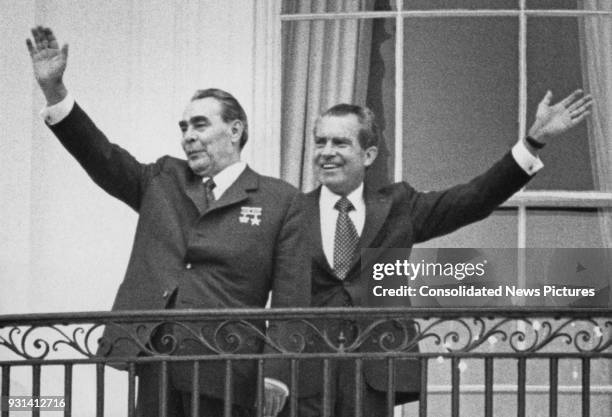 Russian leader Leonid Brezhnev and US President Richard Nixon wave from the balcony of the White House in Washington, DC, during their week of talks,...