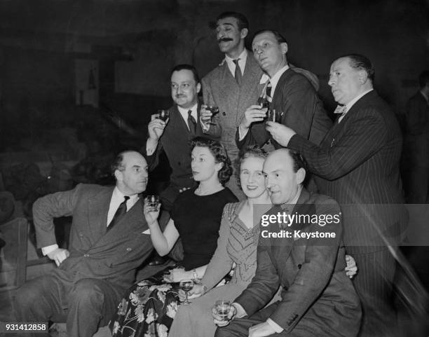 The cast of the radio show 'Much-Binding-in-the-Marsh' celebrate their 100th performance at the Paris Cinema in London, 12th April 1949. Pictured are...
