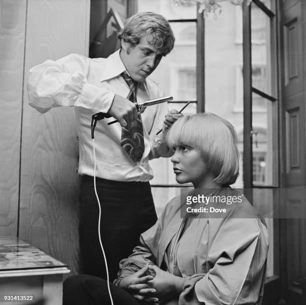 British celebrity hairdresser Gavin Hodge styling hair of his wife, former debutante Jayne Harries, in his Mayfair salon, London, UK, 24th August...