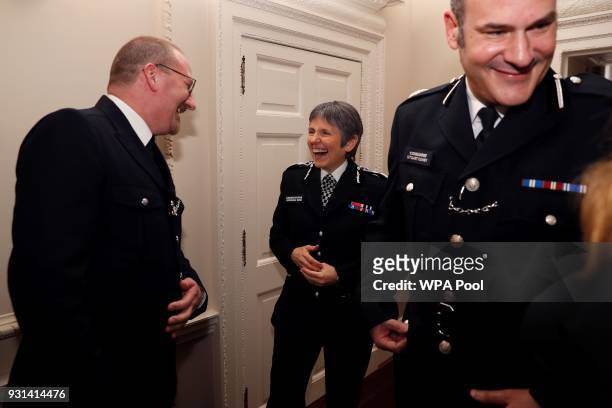 Britain's Metropolitan Police Commissioner Cressida Dick and Police commander Stuart Cundy react as they talk with police officer of the year, PC...