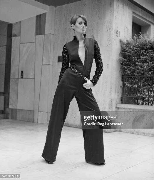 Fashion model wearing black flare trousers crepe jumpsuit by Yves Saint Laurent, Paris, France, 19th August 1968.