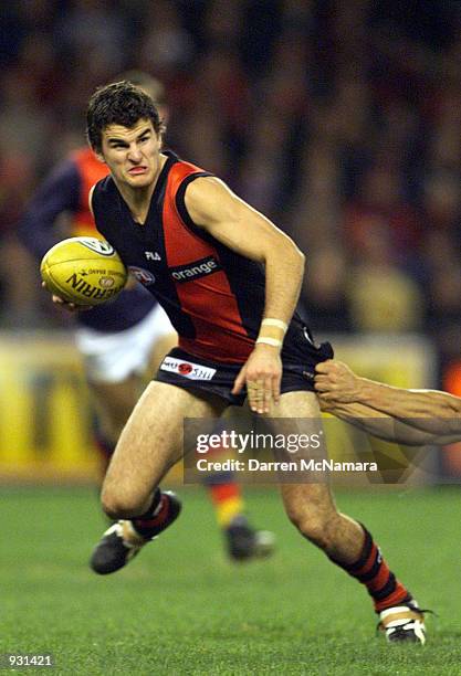 Damien Peverill for Essendon, attempts to break free from his Adelaide opponant, during the match between the Essendon Bombers and the Adelaide...