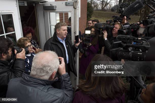 Rick Saccone, Republican candidate for the U.S. House of Representatives, holds a smartphone while speaking to members of the media after voting at...