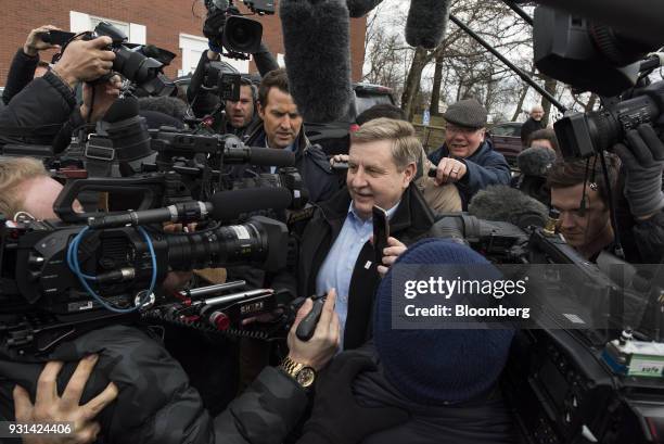 Rick Saccone, Republican candidate for the U.S. House of Representatives, holds a smartphone while speaking to members of the media after voting at...