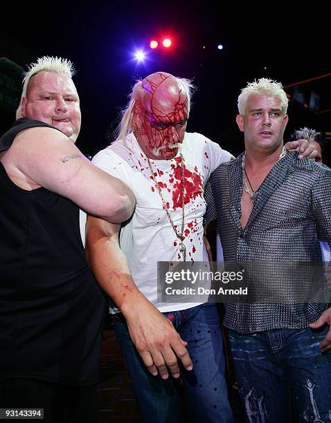 Hulk Hogan is escorted to a backstage area after an altercation involving Ric Flair by Brian Knobbs and Brutus Beefcake during a press conference for...