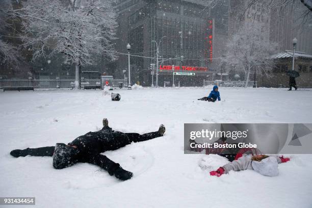 Kimberly Furmonavicius, left, and her daughter Sloane of Boston make snow angels on the Boston Common as snow falls during the third nor'easter storm...