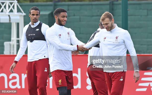 Ragnar Klavan with Joe Gomez and Joel Matip of Liverpool during a training session at Melwood Training Ground on March 13, 2018 in Liverpool, England.