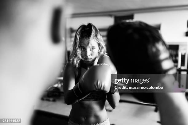 woman boxer workout with coach - boxen sport stock-fotos und bilder