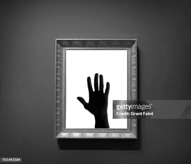 silhouette of hand in picture frame on wall - vancouver art gallery stock pictures, royalty-free photos & images
