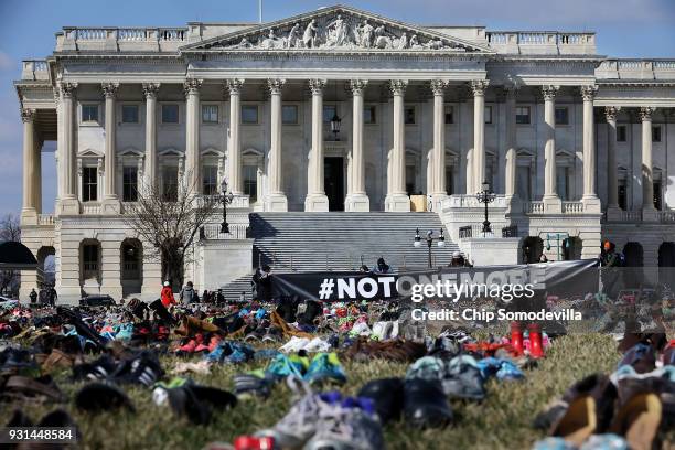 Seven thousand pairs of shoes, representing the children killed by gun violence since the mass shooting at Sandy Hook Elementary School in 2012, are...