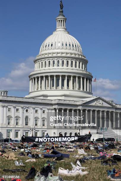 Seven thousand pairs of shoes, representing the children killed by gun violence since the mass shooting at Sandy Hook Elementary School in 2012, are...