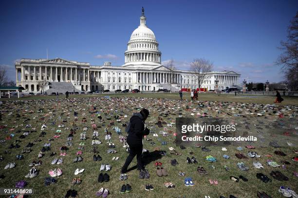 Seven thousand pairs of shoes, representing the children killed by gun violence since the mass shooting at Sandy Hook Elementary School in 2012, are...