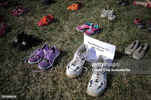 Seven thousand pairs of shoes, representing the children killed by gun violence since the mass shooting at Sandy Hook Elementary School in 2012, are...