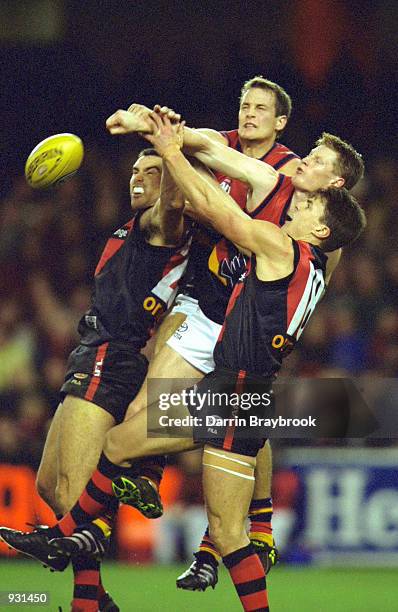 Mark Stevens for Adelaide, attempts to mark infront of Scott Lucas and Matthew Lloyd for Essendon, during the match between the Essendon Bombers and...