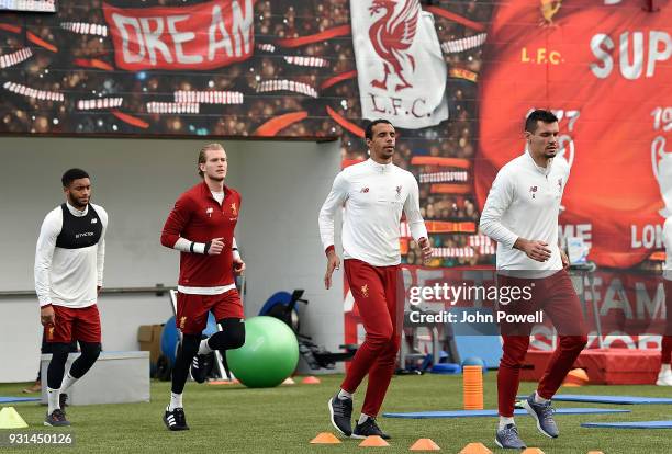 Joe Gomez, Loris Karius, Joel Matip and Dejan Lovren of Liverpool during a training session at Melwood Training Ground on March 13, 2018 in...