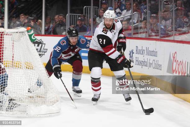 Derek Stepan of the Arizona Coyotes skates against Gabriel Landeskog of the Colorado Avalanche at the Pepsi Center on March 10, 2018 in Denver,...