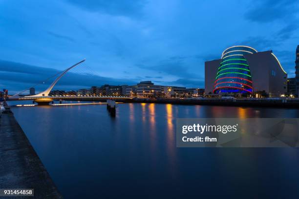 samuel beckett bridge in dublin with liffey river and city skyline (dublin/ ireland) - convention centre dublin stock pictures, royalty-free photos & images