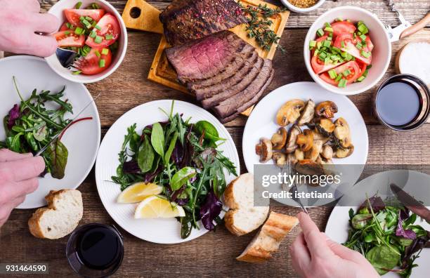 eating tasty food. favorite meal - food table stock-fotos und bilder