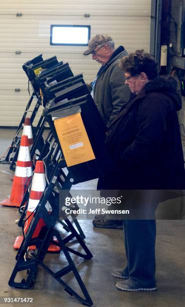 Voters place their ballots in a special election between Democratic candidate Conor Lamb and Republican candidate Rick Saccone March 13, 2018 at the...