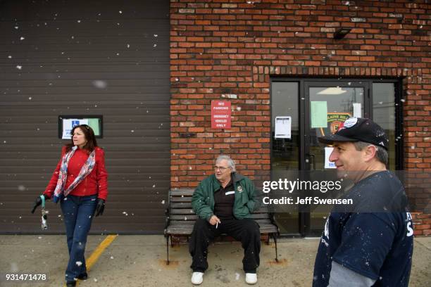 Volunteers Lesa DeMaio, left, and her husband, Bernie, right, greet voters showing up to place their ballots in a special election between Democratic...