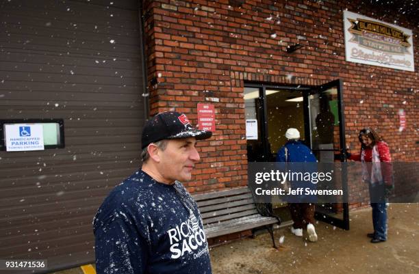 Volunteers Bernie DeMaio, left, and his wife, Lesa, right, greet voters showing up to place their ballots in a special election between Democratic...