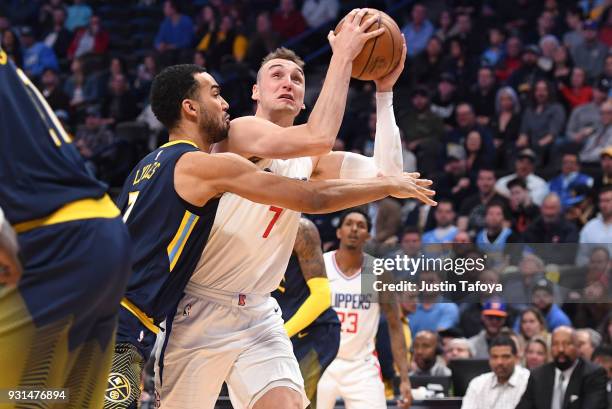 Sam Dekker of the LA Clippers is guarded by Trey Lyles of the Denver Nuggets at Pepsi Center on February 27, 2018 in Denver, Colorado. NOTE TO USER:...