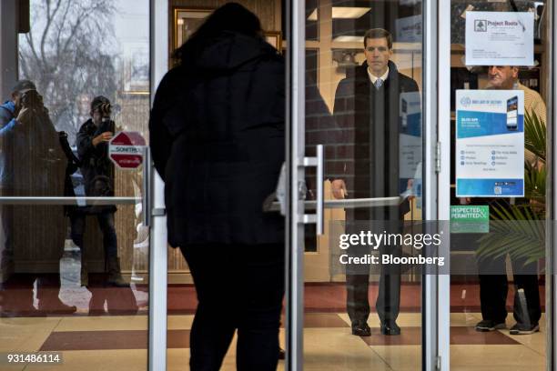 Conor Lamb, Democratic candidate for the U.S. House of Representatives, center, stands in the Our Lady of Victory Church polling location in...