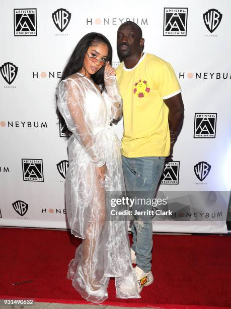 Saweetie and Bu Thiam attend Saweetie's "High Maintenance" Listening Event on March 12, 2018 in Hollywood, California.