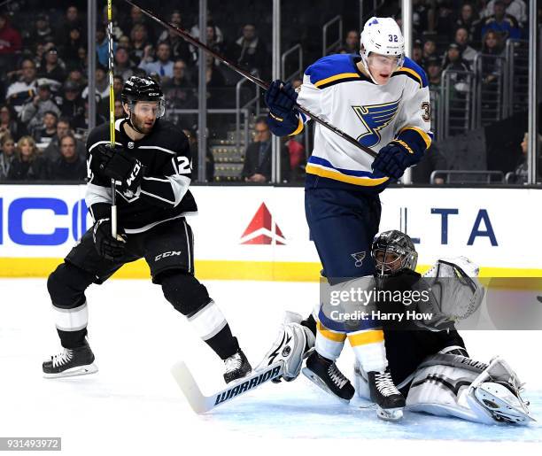 Jonathan Quick of the Los Angeles Kings makes a save in front of Tage Thompson of the St. Louis Blues as Derek Forbort of the Los Angeles Kings looks...