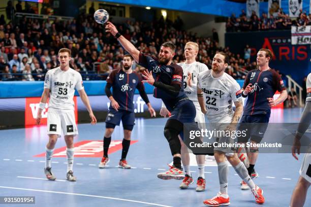 Luka Karabatic of Paris Saint Germain is shooting the ball against Ole Rahmel of THW Kiel during the Champions League match between Paris Saint...