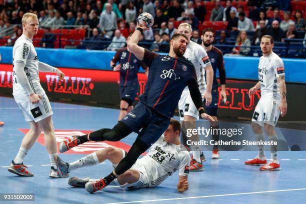 Luka Karabatic of Paris Saint Germain is shooting the ball against Nikola Bilyk of THW Kiel during the Champions League match between Paris Saint...