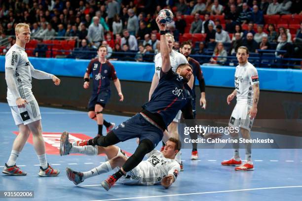 Luka Karabatic of Paris Saint Germain is shooting the ball against Nikola Bilyk of THW Kiel during the Champions League match between Paris Saint...