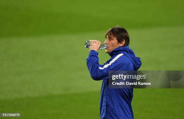 Antonio Conte, Manager of Chelsea takes a drink during a Chelsea training session on the eve of their UEFA Champions League round of 16 match against...