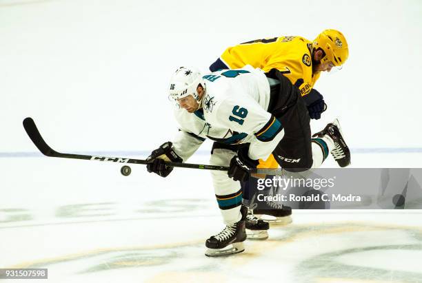 Eric Fehr of the San Jose Sharks skates against Yannick Weber of the Nashville Predators during an NHL game at Bridgestone Arena on February 22, 2018...