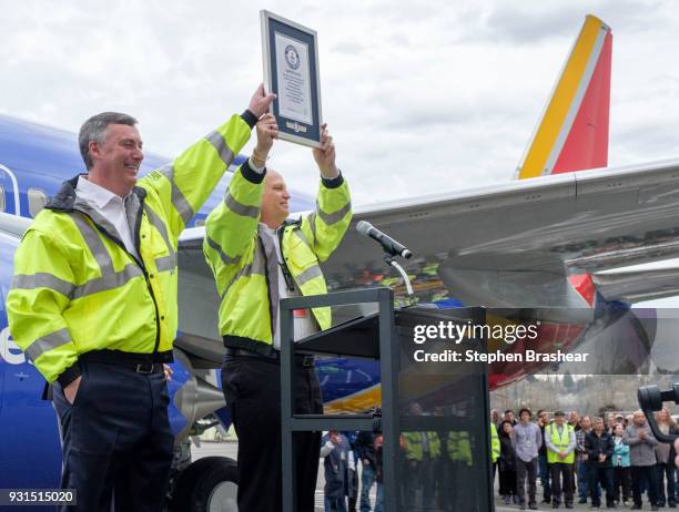 Boeing Commercial Airplanes president and CEO Kevin McAllister, left, and vice president and general manager of the 737 program Scott Campbell hold...