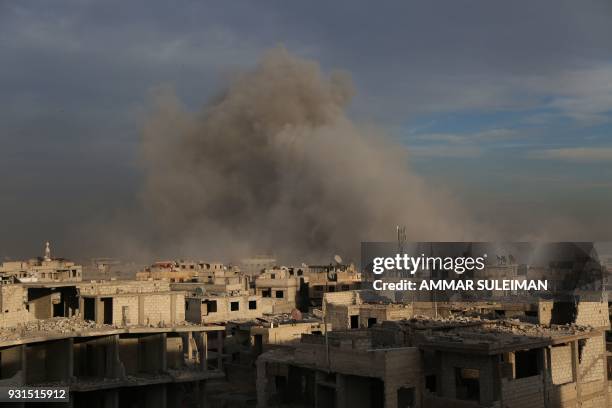 Smoke billows following government bombardment in Kafr Batna in the rebel-held enclave of Eastern Ghouta on March 13, 2018. A day earlier, the United...