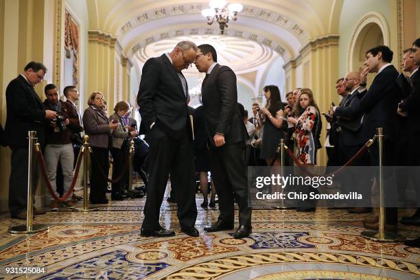 Senate Minority Leader Charles Schumer hears from his communications director Matt House during a news conference following the regular Democratic...