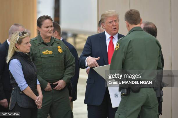 President Donald Trump is shown border wall prototypes in San Diego, California on March 13, 2018. / AFP PHOTO / MANDEL NGAN