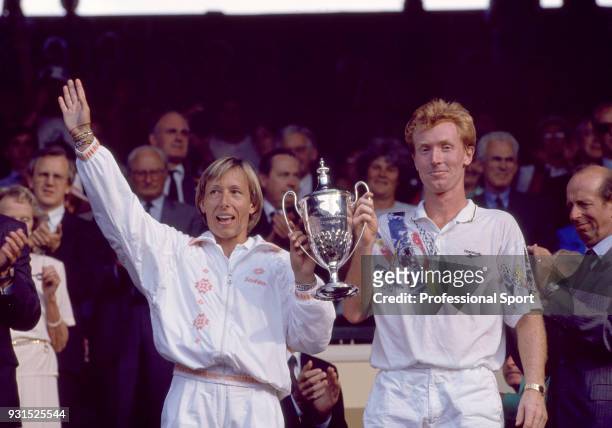 Martina Navratilova of the USA and Mark Woodforde of Australia pose with the trophy after defeating Manon Bollegraf and Tom Nijssen both of the...