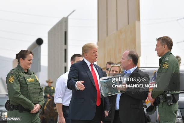 President Donald Trump is shown border wall prototypes in San Diego, California on March 13, 2018. / AFP PHOTO / MANDEL NGAN